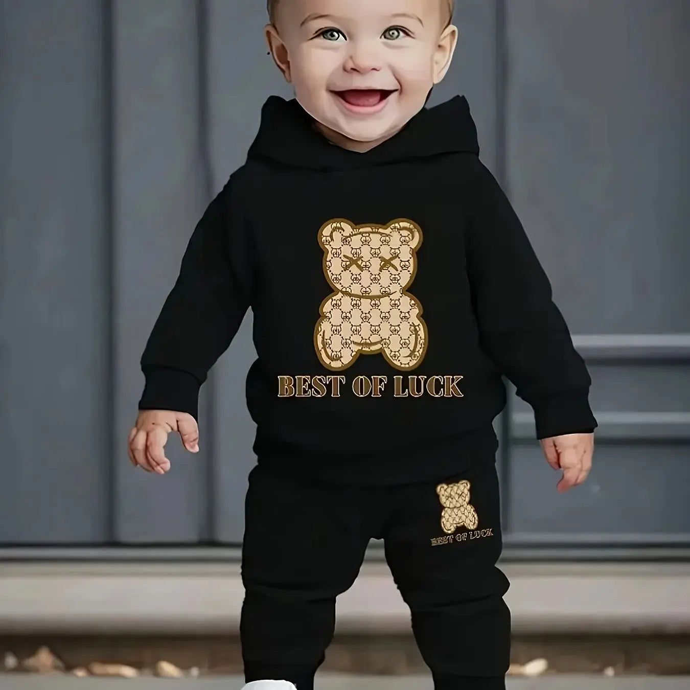 A two-piece cartoon printed fleece hoodie and long pants set for a newborn baby boy in autumn and winter